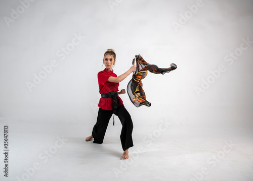 beautiful girl in black and red dancing with a combat scarf