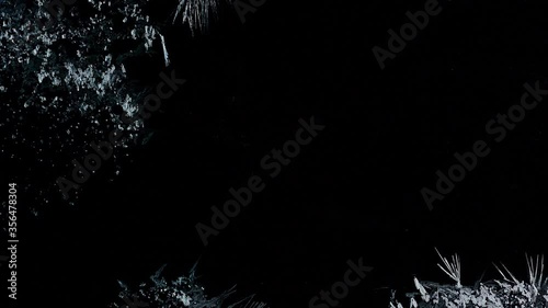 Ice Forming process 4K, Window freezing on dark background. Ice growind with dots and spikes