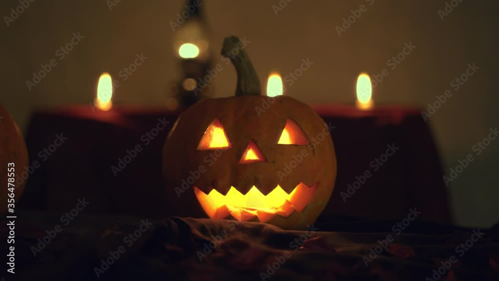 Halloween laughing pumpkin. Background candles and kerosene lamp. Camera dolly movement to the right .. Animated pumpkin. Halloween art design. Halloween laughing pumpkin. Background candles and kerosene lamp. Camera dolly movement to the right .. Animated pumpkin. Halloween art design.