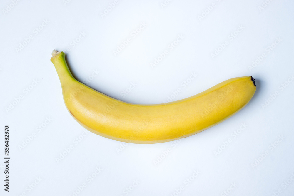Banana on a white background. Photo from above. Banana as a background. Yellow beautiful banana