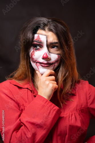 A portrait of a thinking clown lady