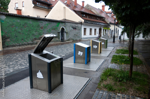 underground metal garbage containers for separate collection of garbage on a narrow street in the old part of Ljubljana