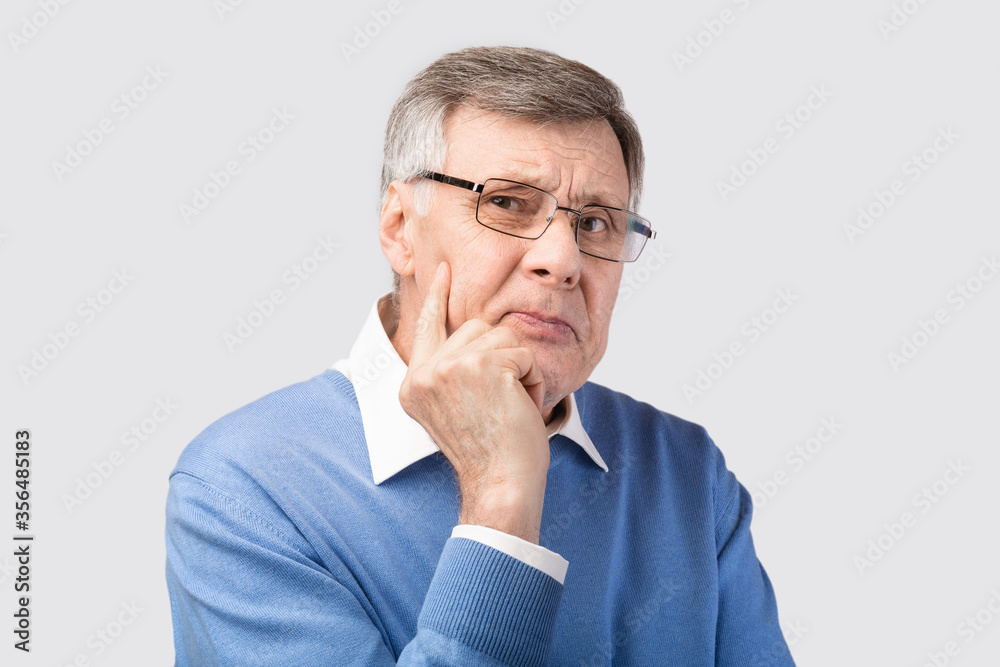 Thoughtful Senior Gentleman Thinking Looking At Camera Posing, Gray Background Thoughtful Senior Gentleman Thinking Looking At Camera Posing, Gray Background