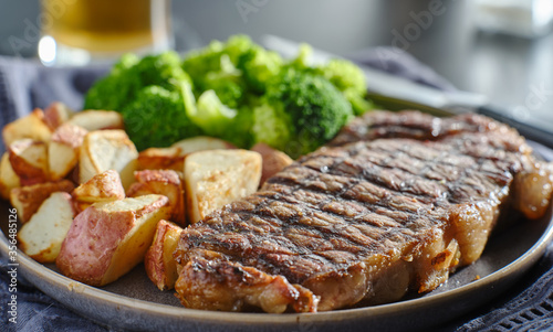 grilled new york steak with broccoli and roasted potatoes