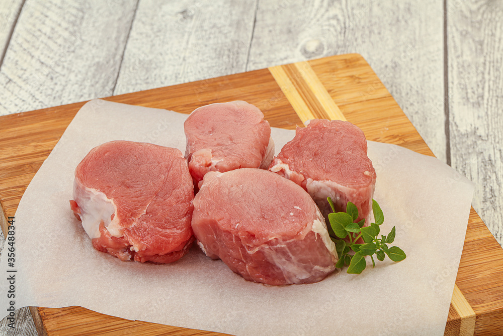 Raw pork medallion served rosemary Raw pork medallion served rosemary