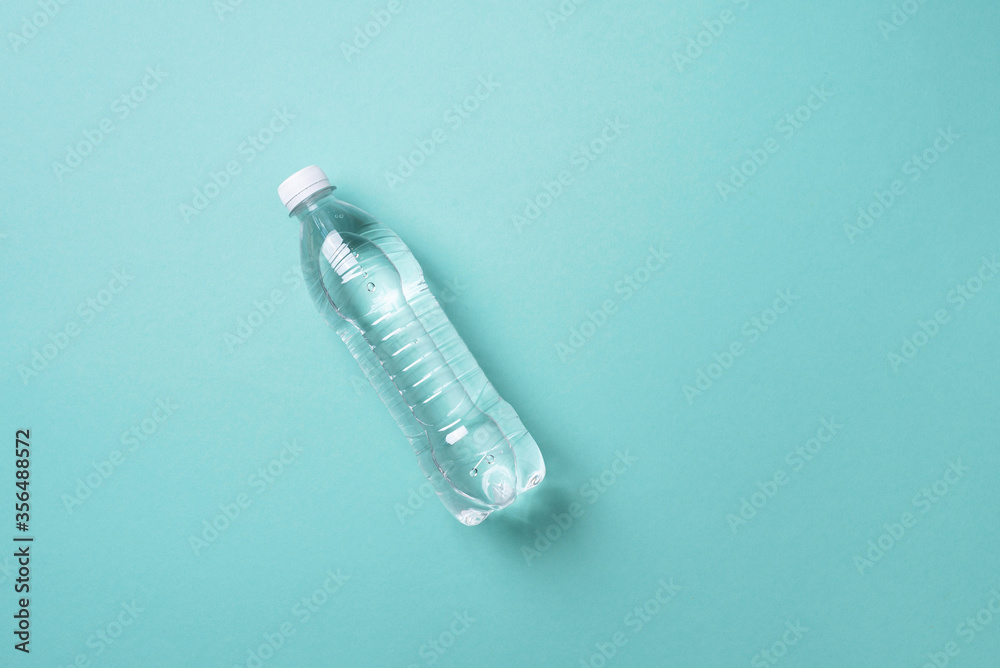 Water balance. Pure water in bottle for healthy lifestyle on blue background. Top view. Copy space. World water day. Pollution, environmental protection concept. Global water crisis and problem Water balance. Pure water in bottle for healthy lifestyle on blue background. Top view. Copy space. World water day. Pollution, environmental protection concept. Global water crisis and problem