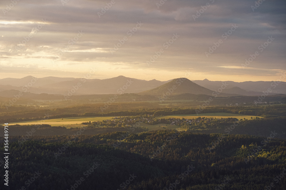 Sunset in the mountains of Saxon Switzerland view to the river Elbe and a village. Sunset in the mountains of Saxon Switzerland view to the river Elbe and a village.