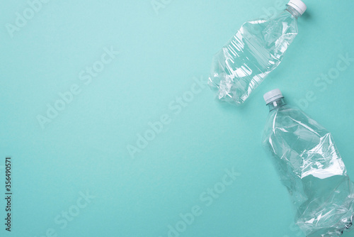 Fotografija Empty rumpled used plastic bottle on blue background