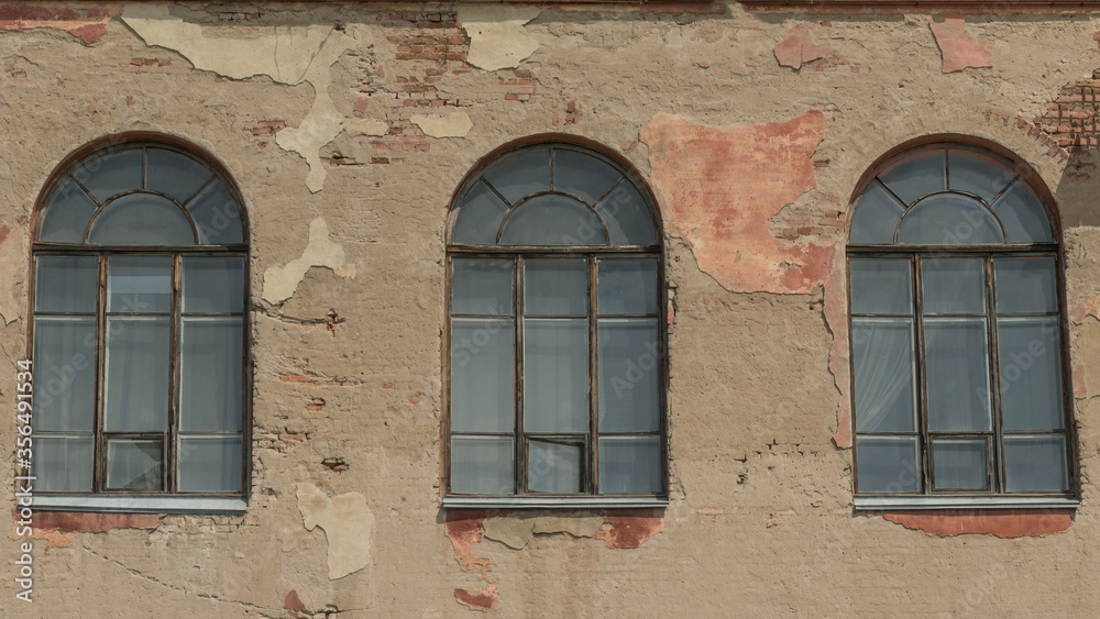 Three old arched windows of a building