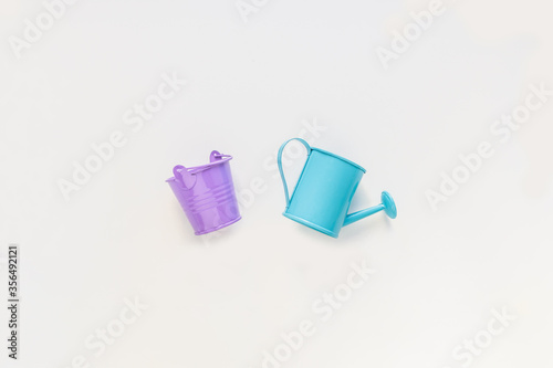 Toys, iron turquoise watering can and violet bucket