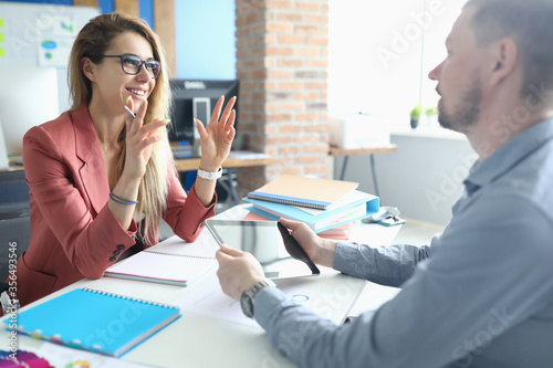 Two adult business people make work interview against office background.One on one meeting concept.