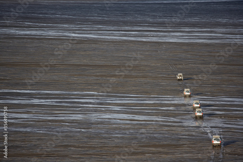 SUV's crossing glacier wetlands on GÊsavatnalei in central Iceland