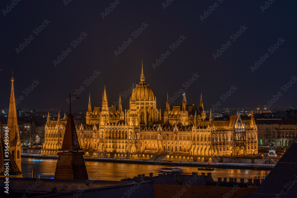 Danube river side view of Hungarian Parliament in the night from pest hill