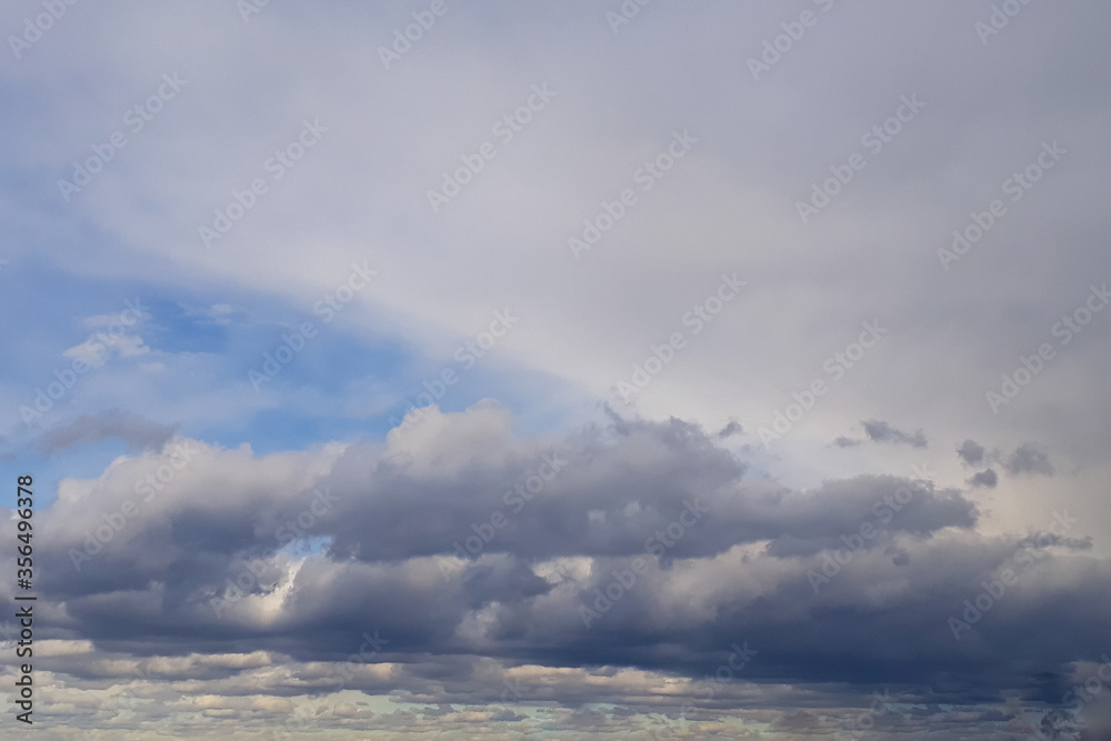 Heavy gray rain clouds in the blue sky. Atmosphere, air, cloudy, soon rain. Heavy gray rain clouds in the blue sky. Atmosphere, air, cloudy, soon rain.