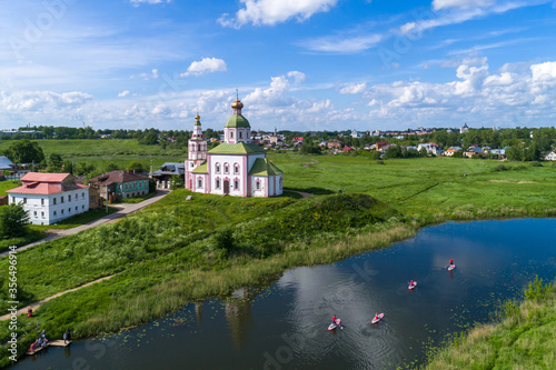 Suzdal, Russia. Tourists traveling on SUP boards along the Suzdal River.