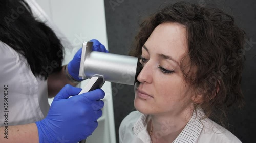 Close up view of dermatovenereologist analyzes the mole in a cosmetology clinic, dermatooncologist. photo