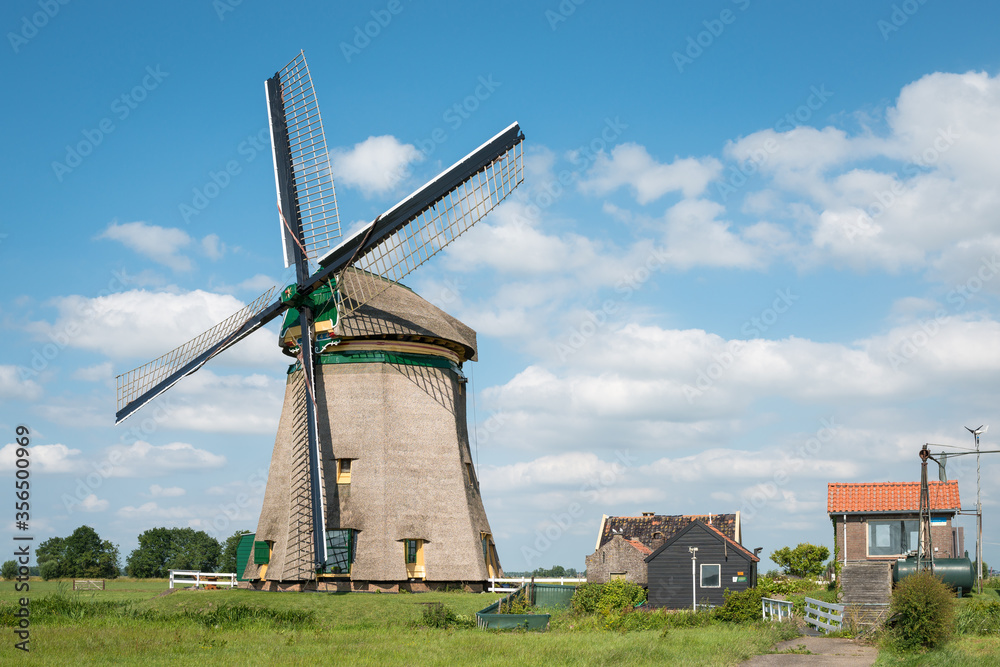 Traditional Dutch windmill with pumping house
