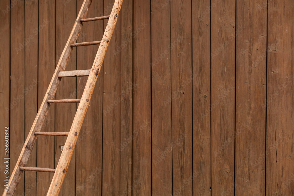 Old wooden ladder in front of wooden wall. Step ladder against a wall. Growth, future, development concept. Alte Holzleiter vor Holzwand. Trittleiter, Wachstum, Zukunft, Entwicklungskonzept. Old wooden ladder in front of wooden wall. Step ladder against a wall. Growth, future, development concept. Alte Holzleiter vor Holzwand. Trittleiter, Wachstum, Zukunft, Entwicklungskonzept.