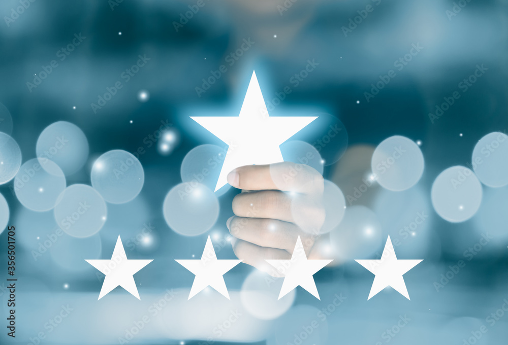 Obraz premium Hand holding star symbol give five stars rating. Reviews and Evaluation concept.