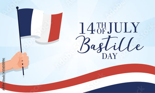 bastille day celebration card with hand waving france flag photo