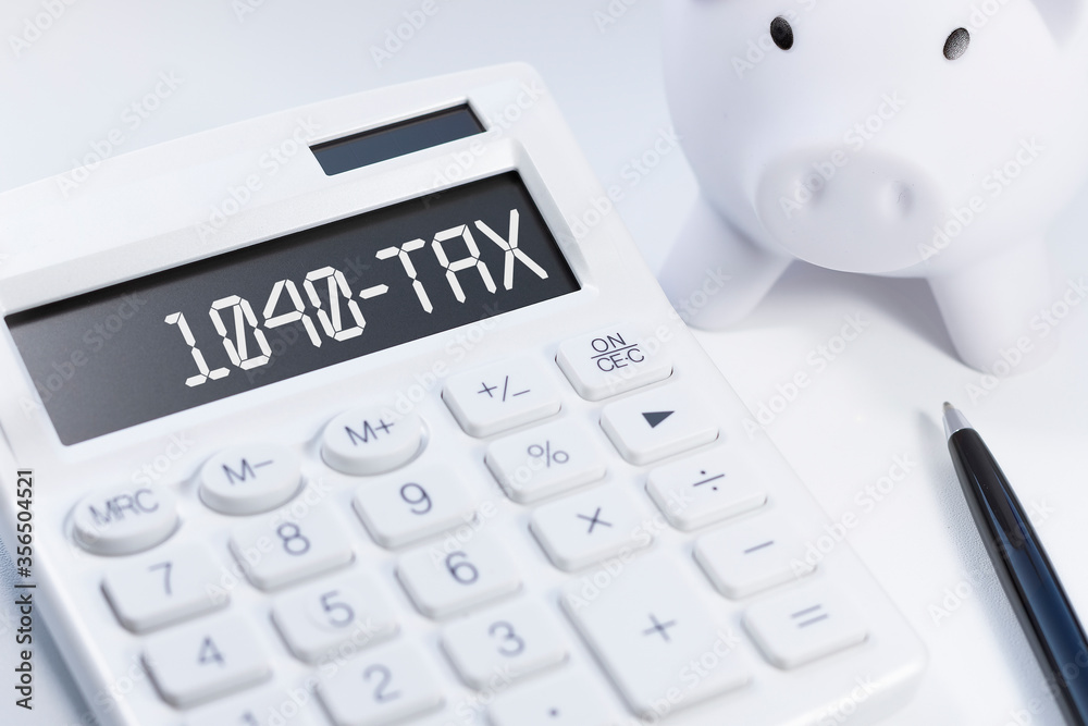 Word 1040-Tax on calculator. Business and tax concept on white background. Top view. Word 1040-Tax on calculator. Business and tax concept on white background. Top view.