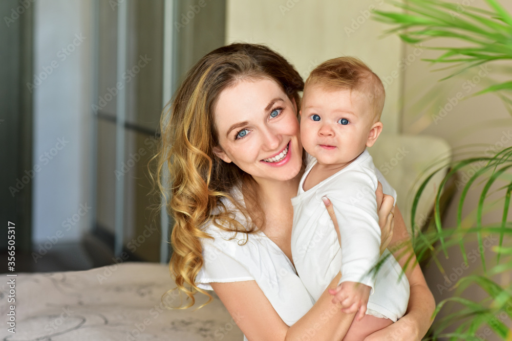 Mother and baby playing and smiling. Happy family.Home interior. Mother and baby playing and smiling. Happy family.Home interior.