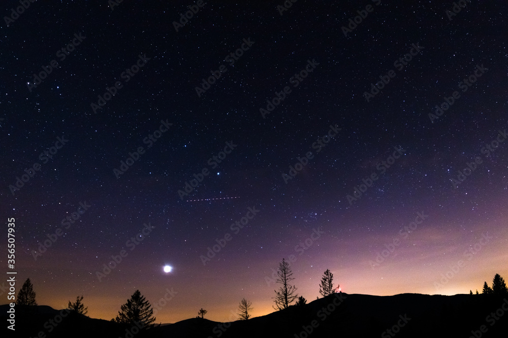 Sunset with stars in the sky and a gradual milky way view of Lysa Hora Czech Republic.