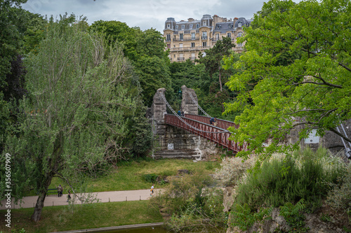 Paris, France - 06 07 2020: View of the Bridge to the island in the Park Buttes Chaumont. © Franck Legros