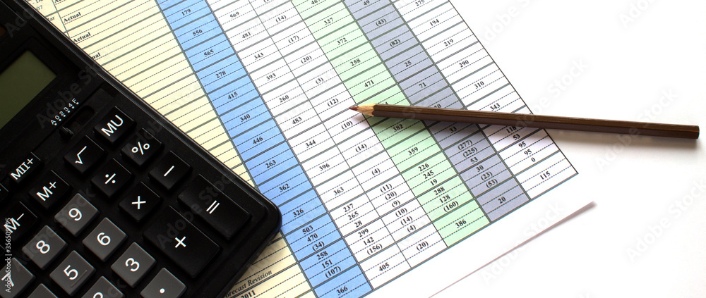 Calculator on the business graphs. Finance conzept Calculator on the business graphs. Finance conzept