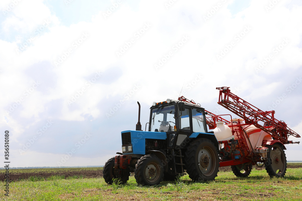Modern agricultural equipment in field under cloudy sky Modern agricultural equipment in field under cloudy sky