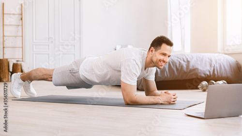 Happy Guy Doing Plank Exercise At Laptop At Home, Panorama