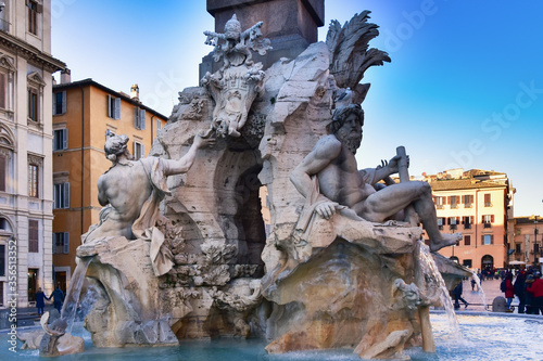 Fountain of the Four Rivers on Piazza Navona. Ancient fountain, statues, obelisk design of Bernini. Famous landmark touristic location near Sant Agnese in Agone church in Rome, Italy