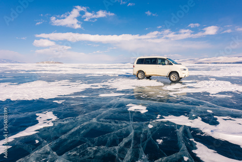 The russian vans on frozen lake baikal, siberia, Russia. The deepest lake in the world with beautiful cracked ice on surface.