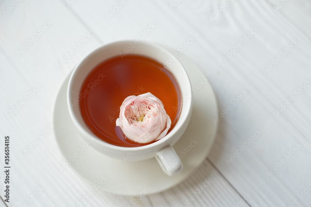 Cup of tea with fresh flowers on a white background. View from above. Space for copy Cup of tea with fresh flowers on a white background. View from above. Space for copy
