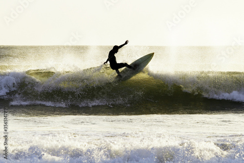 Photography Silhouette man surfing waves at Arraial do Cabo, Rio de Janeiro