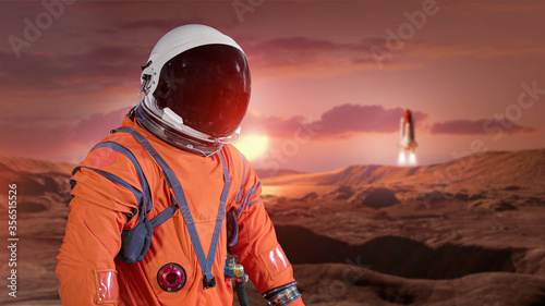 Astronaut on surface of red planet Mars. Martian colonizer. Spaceman and spaceship. Wallpaper of expedition to other worlds. Elements of this image furnished by NASA. © dimazel