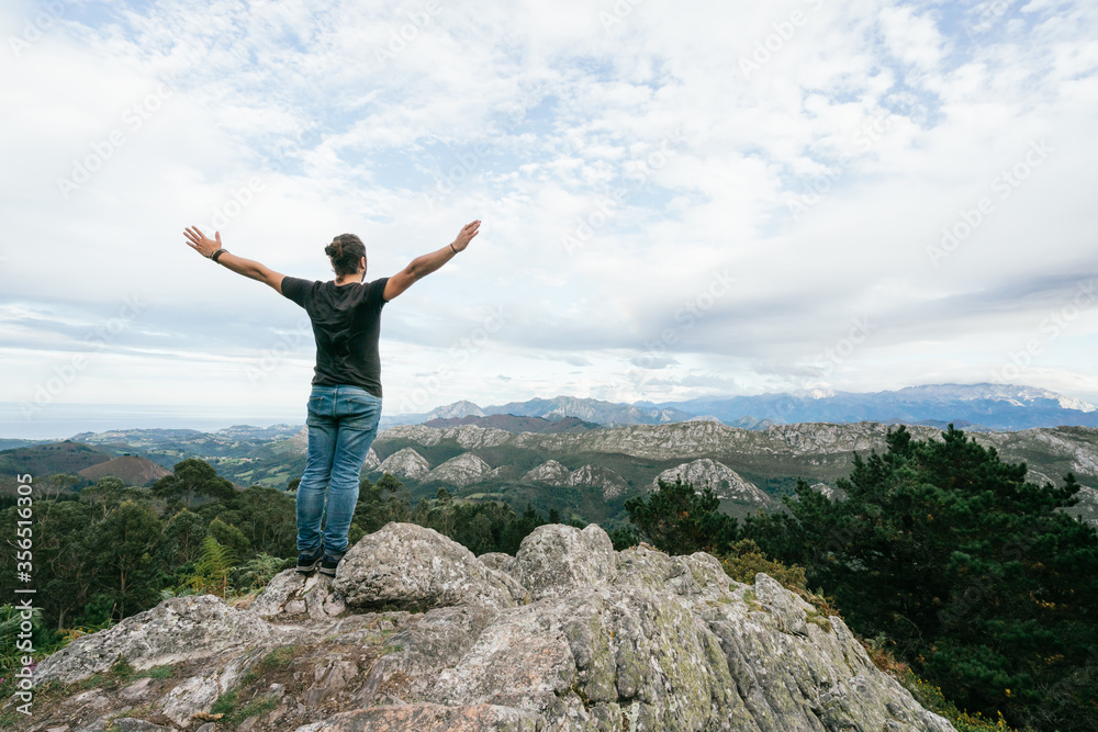 Unrecognizable man walking on hill in nature Unrecognizable man walking on hill in nature