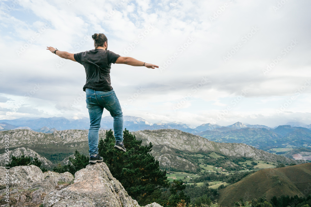 Unrecognizable man walking on hill in nature Unrecognizable man walking on hill in nature