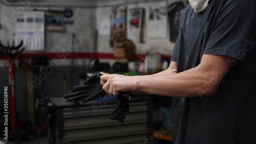 mechanic putting on work gloves