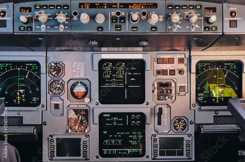 Closeup of control panel with modern facilities and digital displays in cockpit of contemporary aircraft