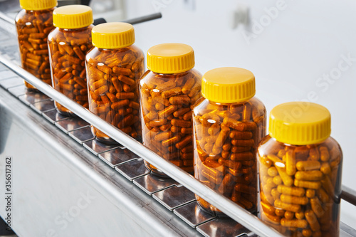 Chain of packaging and manufacture of tablets and vials of tablets and pills industrially for the medical and health sector photo