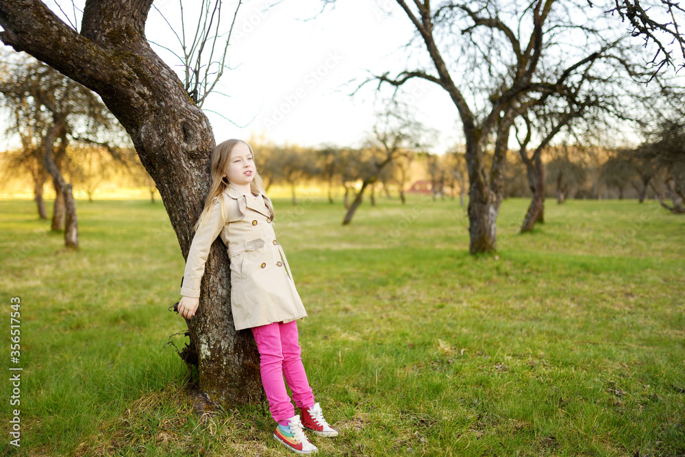 Cute young girl having fun on beautiful spring day. Active family leisure with kids. Family fun outdoors. Cute young girl having fun on beautiful spring day. Active family leisure with kids. Family fun outdoors.