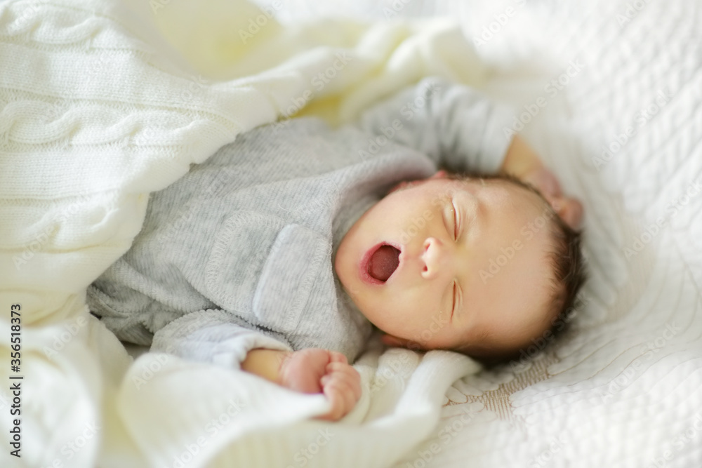 Cute little newborn baby boy sleeping on a blanket. Portrait of tiny new baby at home. New bundle of joy. Cute little newborn baby boy sleeping on a blanket. Portrait of tiny new baby at home. New bundle of joy.