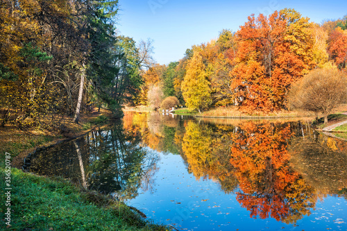 autumn landscape with colorful trees and reflections in the water of a pond in Tsaritsyno park in Moscow
