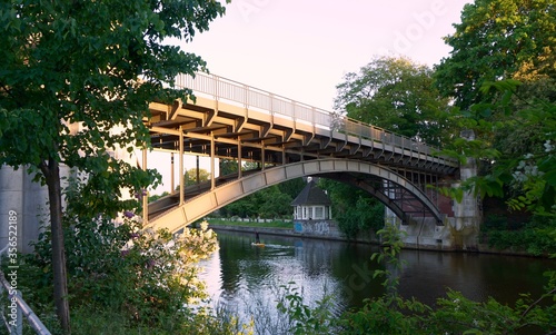 Iron bridge surrounded by trees over the canal. Alster Hamburg. © Mission