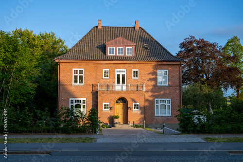 Big red 3 story brick house with 2 chimneys