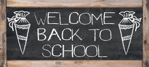 Welcome back to School Background, isolated on rustic wooden chalkboard / blackboard photo