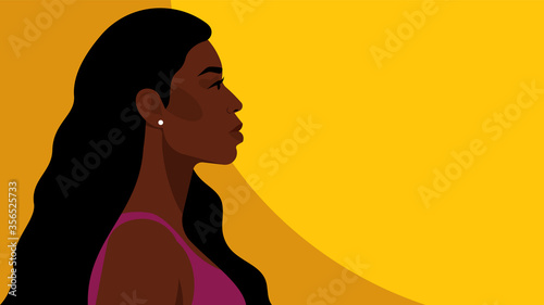 Beautiful black woman with long hair. Young african american. Portrait of young woman with beautiful face. Side view. Yellow background.