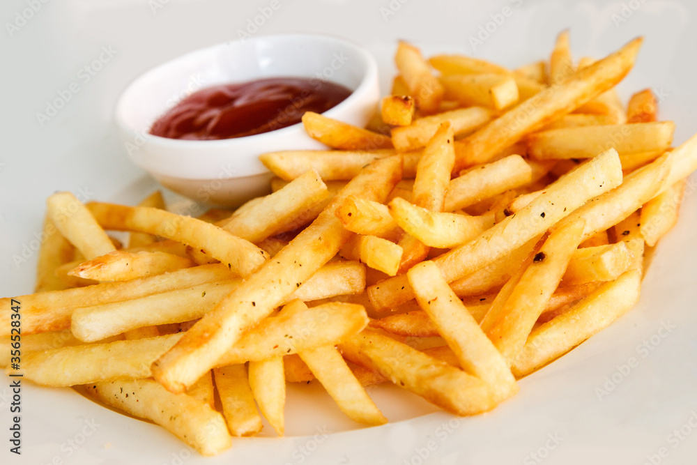 French fries on a white background with tomato sauce French fries on a white background with tomato sauce