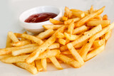 French fries on a white background with tomato sauce